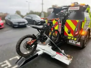A dirt bike being taken away by the police